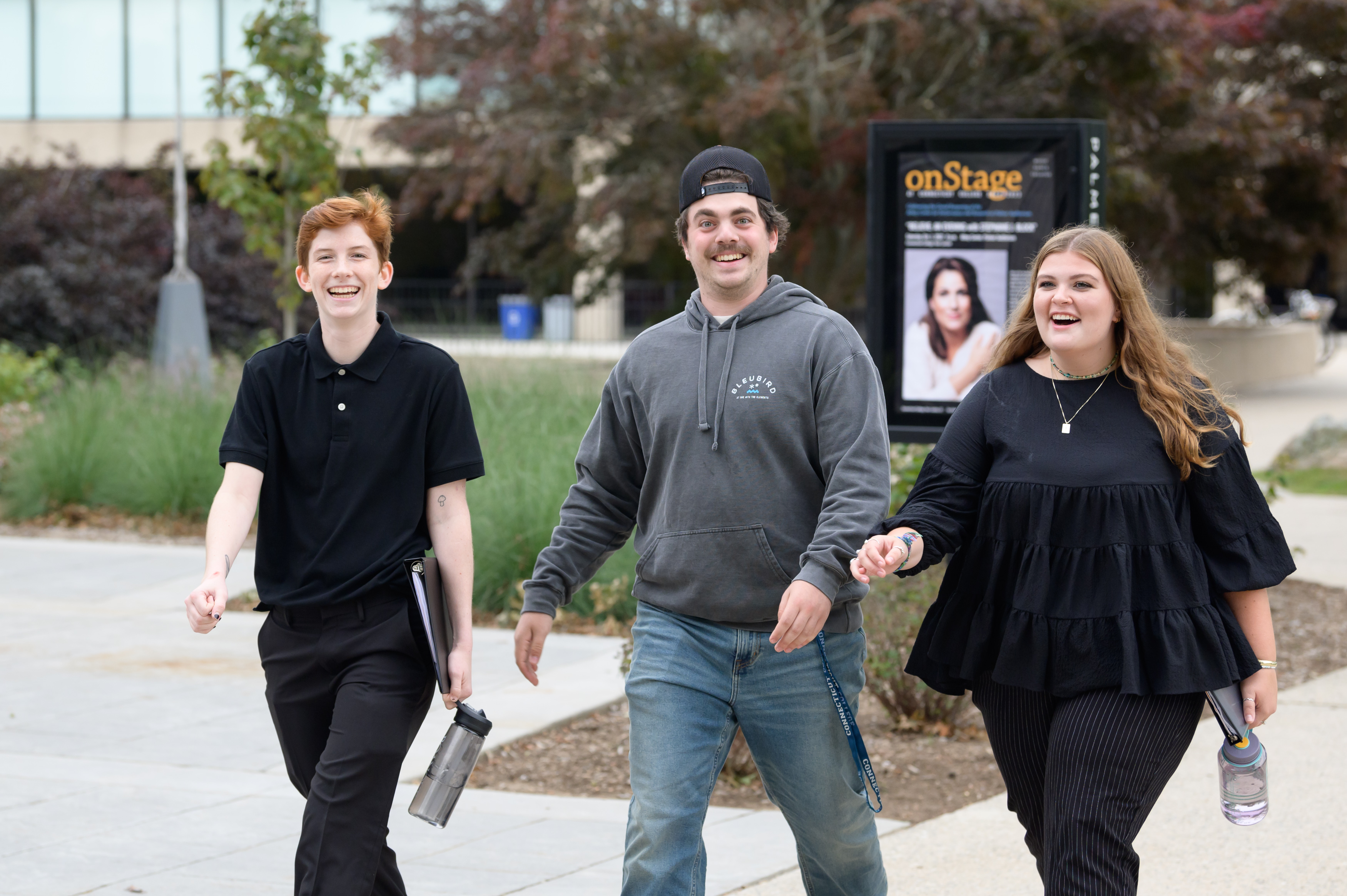 Three students walking past the Athey Center