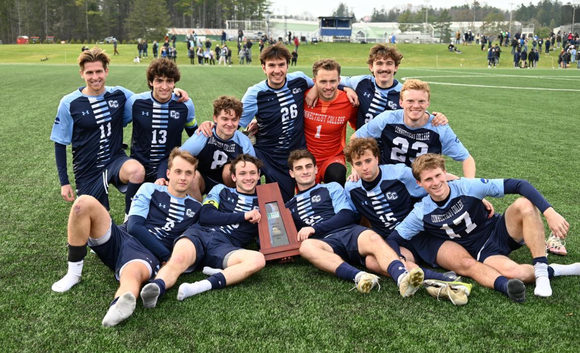 Seniors of the Men's Soccer Team Pose with Trophy.