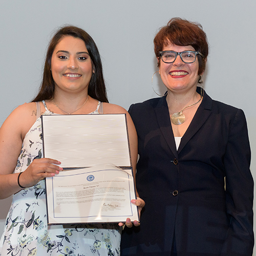 President Katherine Bergeron presenting an alumni award