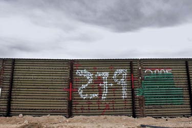 Cloudy sky and border wall that separates Douglas, Arizona, and Agua Prieta, Mexico