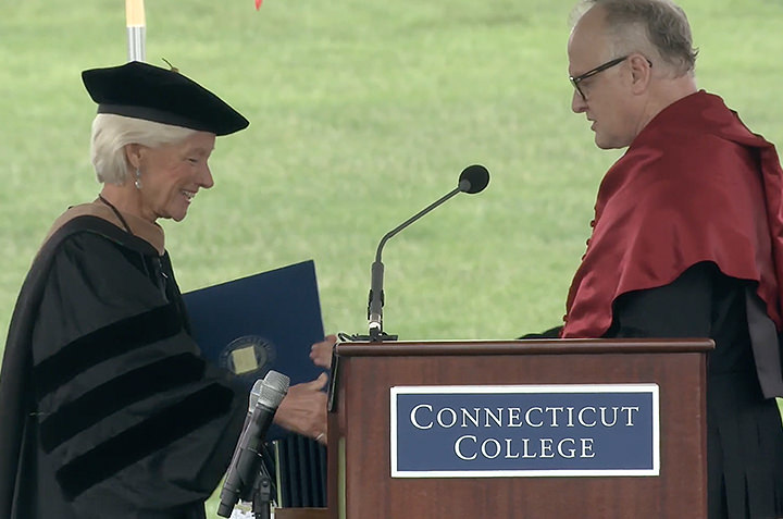 President Bergeron and DeFred G. Folts III present Pam Zilly '75 with the college medal.