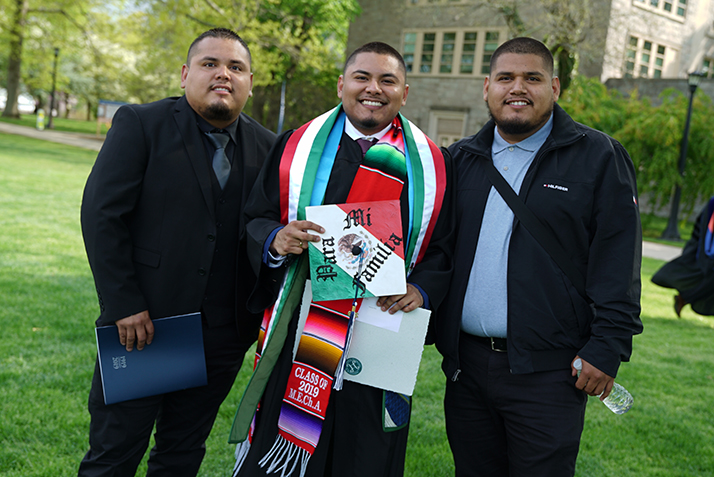 A graduate poses with family members 