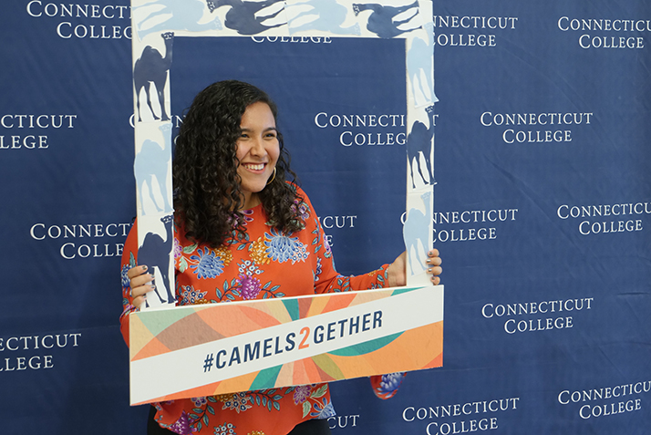 A student poses against the Conn backdrop