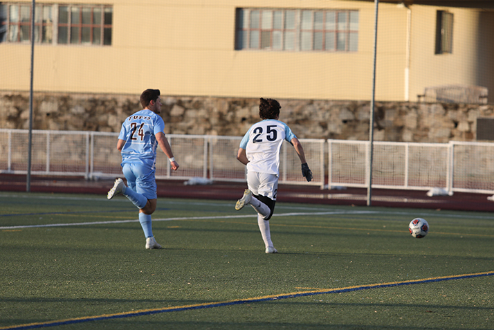 Players run after the ball.