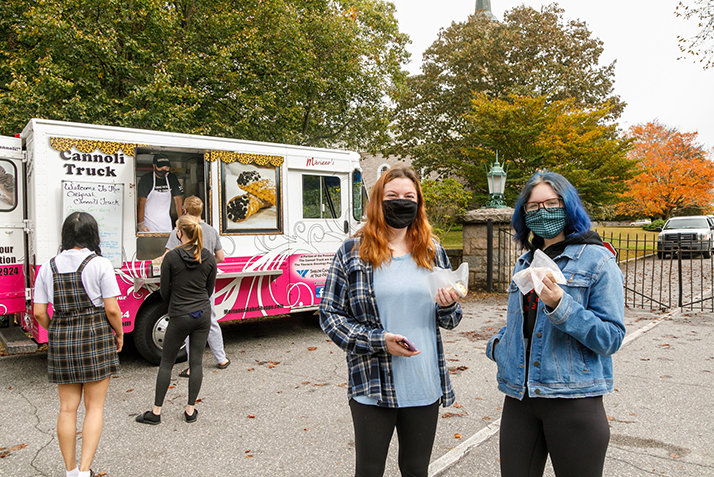 Students celebrate with cannolis.