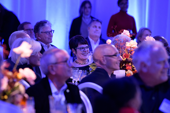 President Katherine Bergeron looks on from her table. 