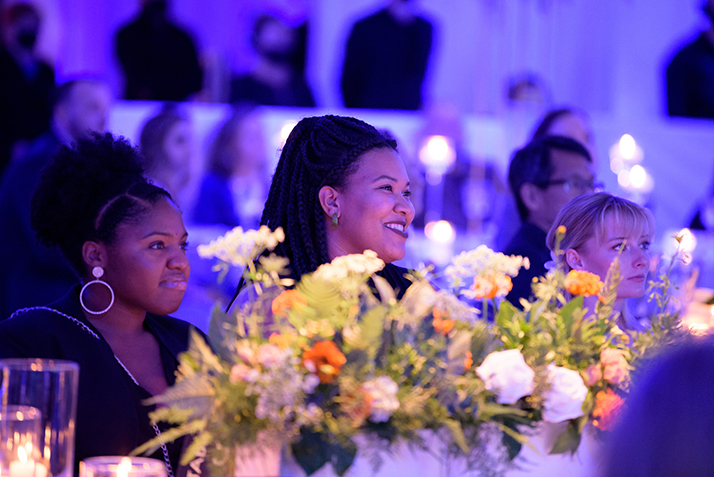 An alumna smiles during the ceremony. 