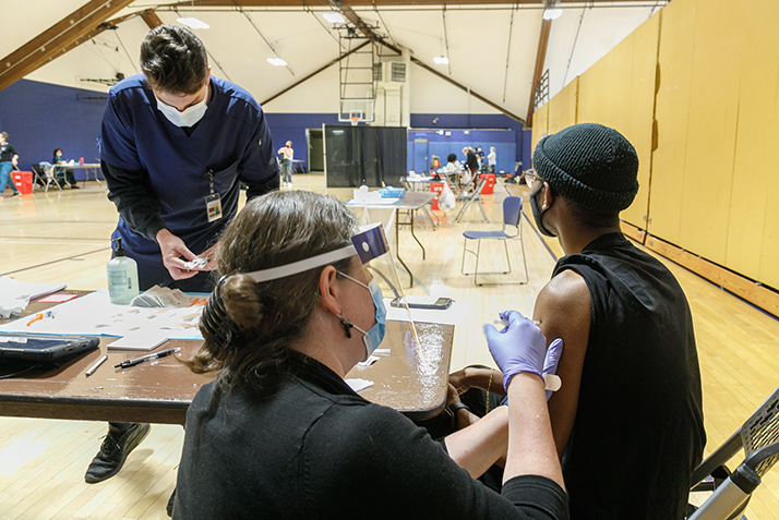 A student receives the COVID-19 vaccine. 