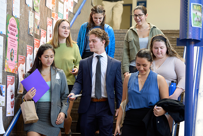 Students walk down a campus staircase during the All-College Symposium