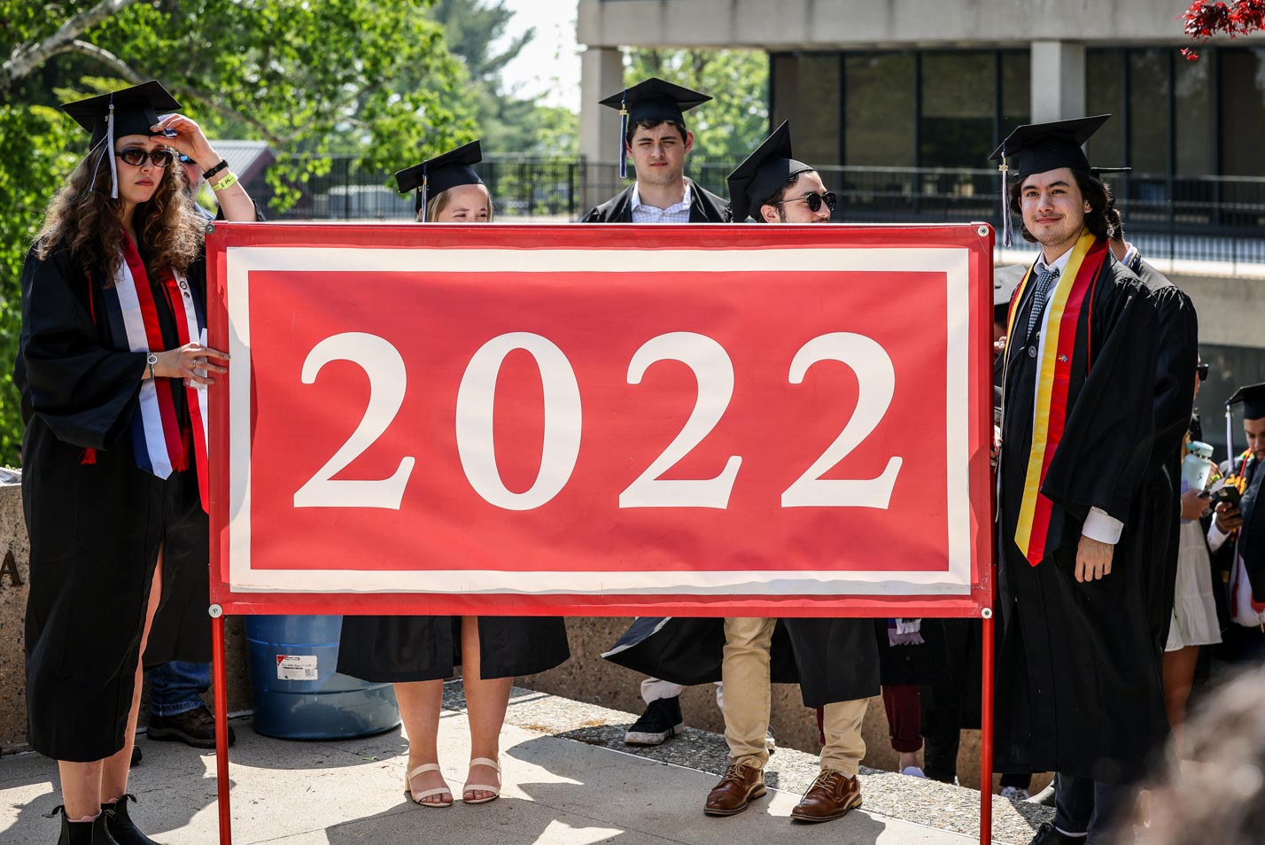 Graduates carry the class flag