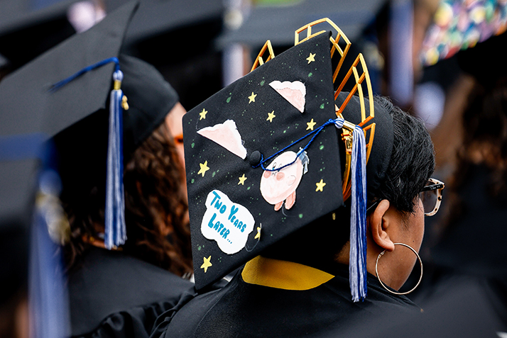 A decorated cap reads, 