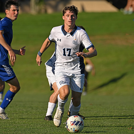 Forward Jake Creus ’24 brings the ball up against Salve Regina in non-league soccer action Sept. 11 on Conn’s Freeman Field.