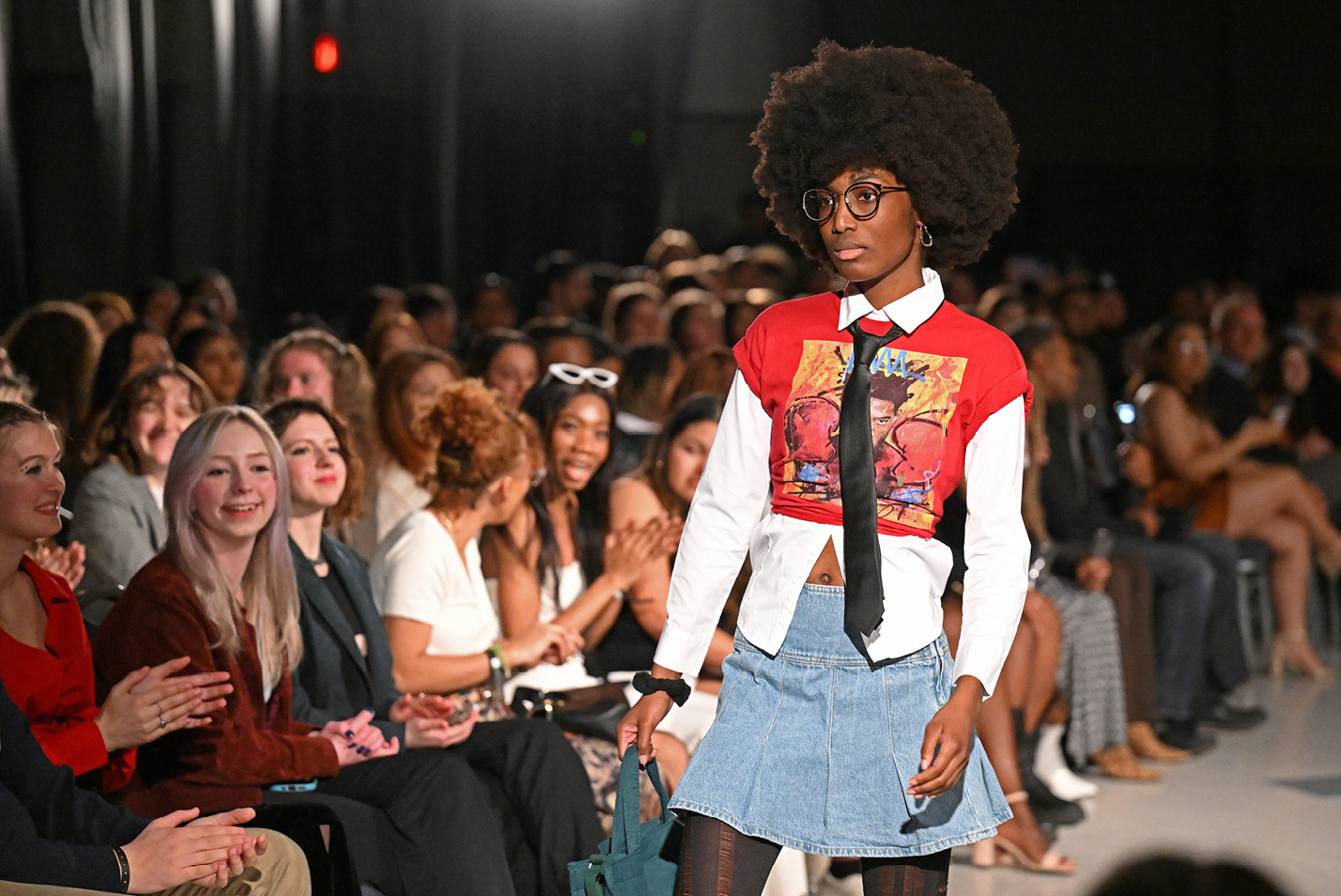 A model poses during the People of Color Alliance (POCA) fashion show “The Blueprint” Saturday, April 8, 2023 in the 1962 Room.