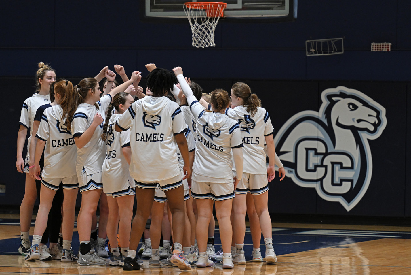 Women's basketball team huddles before a game