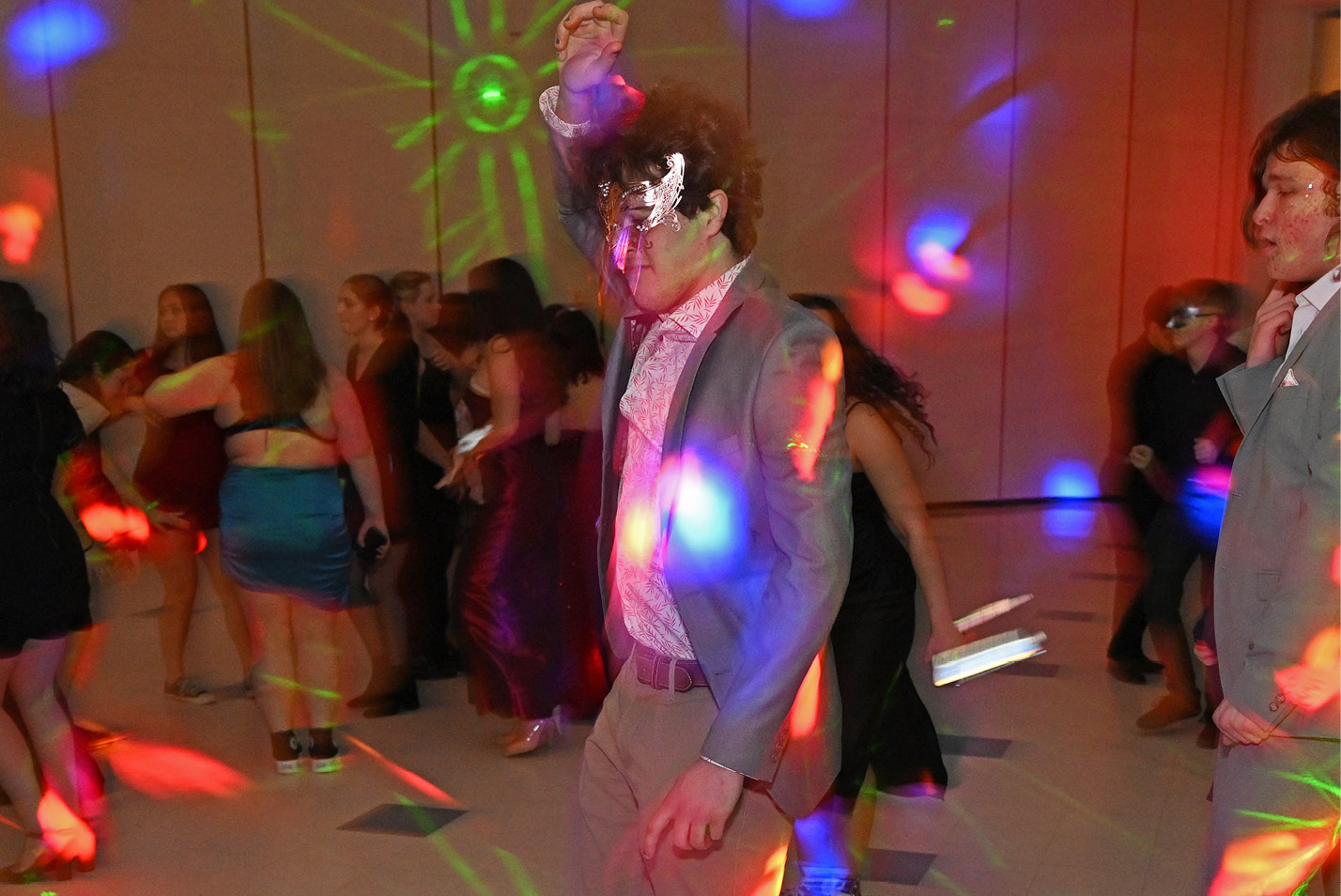 Students dance at the winter formal masquerade ball sponsored by the Student Activities Council in the 1962 Room.