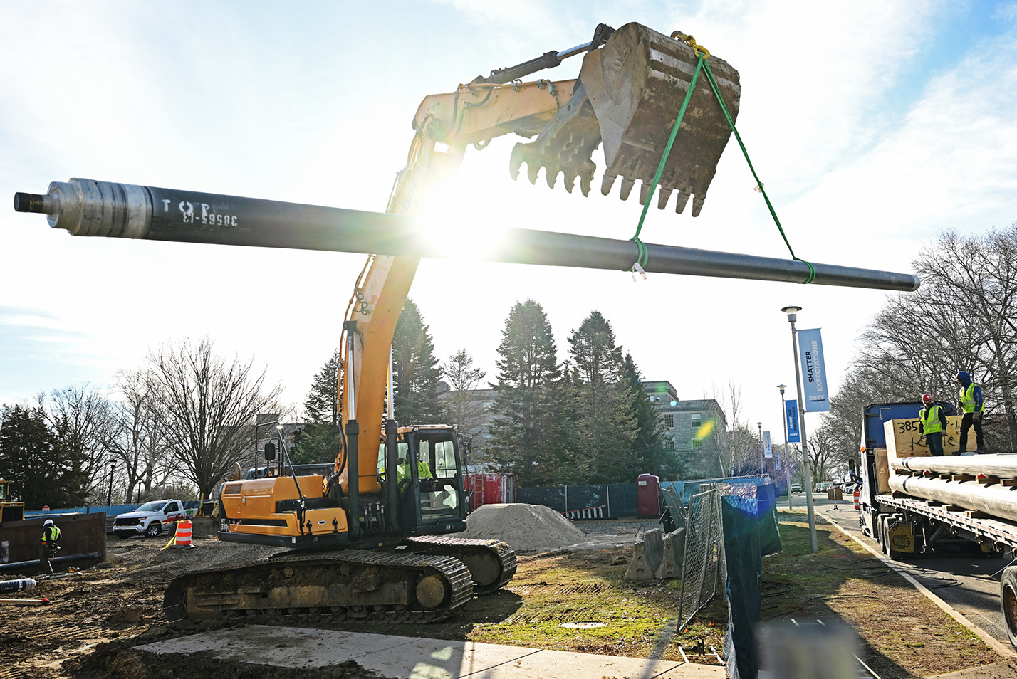 Shot of large bulldozer lifting a steam pipe.