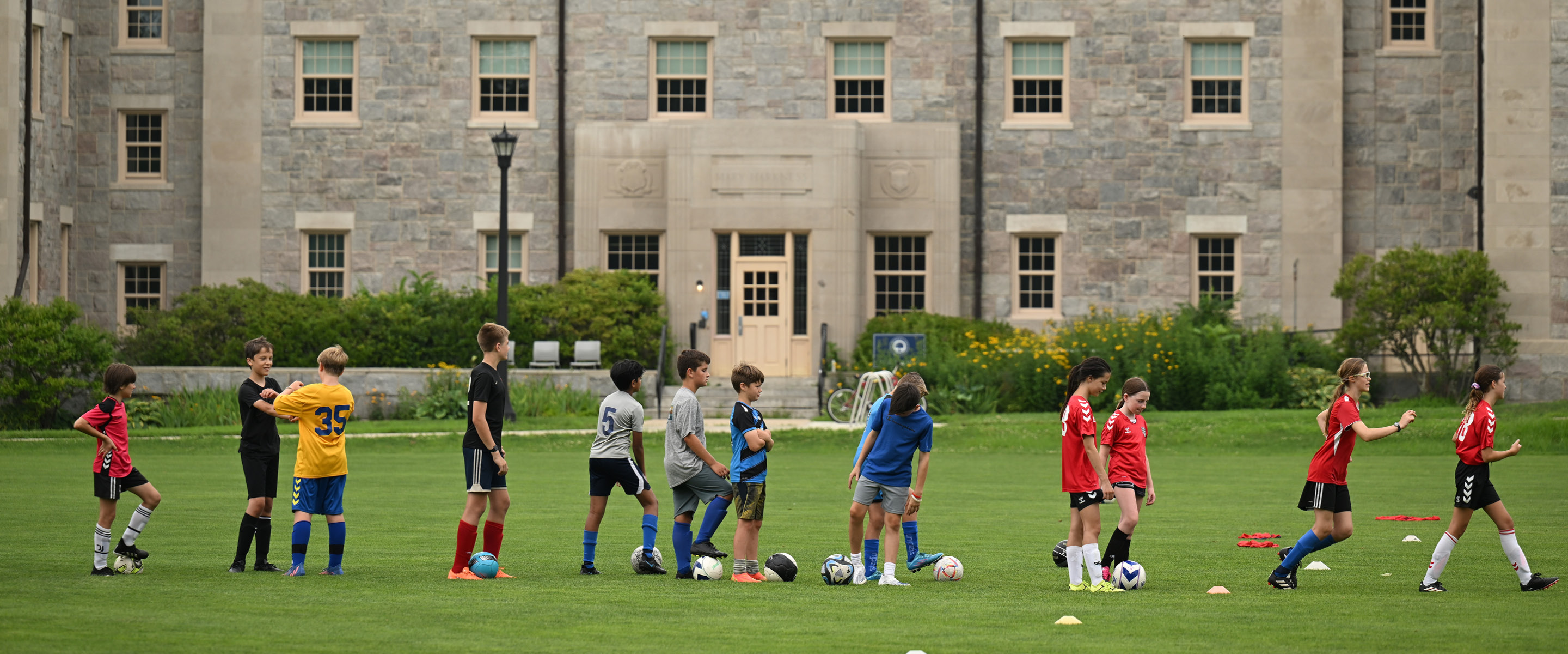 kids at soccer camp on the green