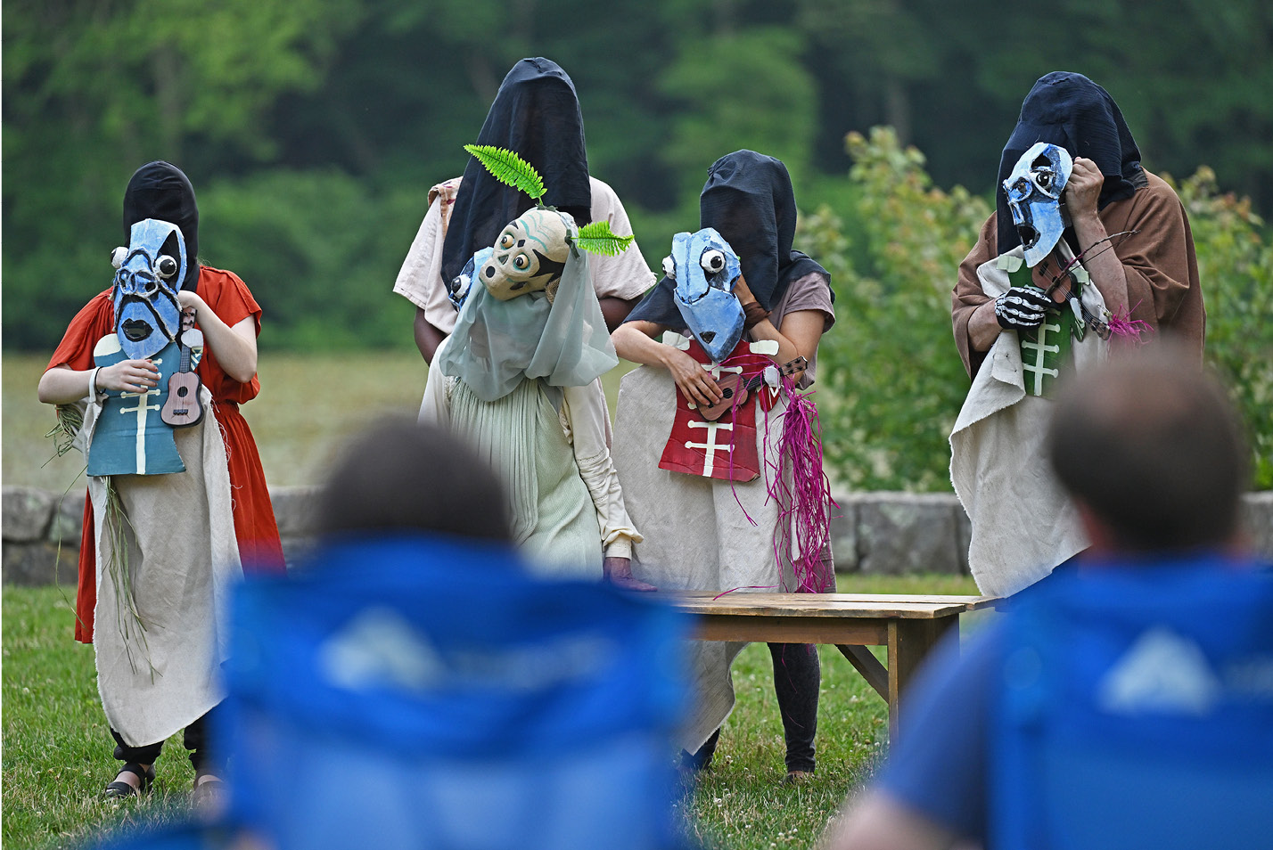 Masked actors perform during Flock Theater's Shakespeare in the Park in the Arboretum