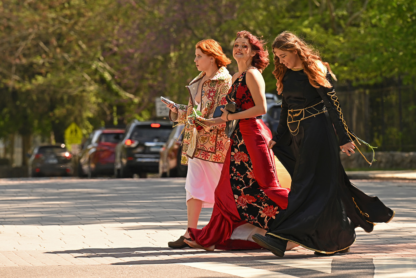 Costuming students, from left, Addie Slade ’24, Joe Duckett ’25, and Ainsley Cornwall ’26 cross Williams Street