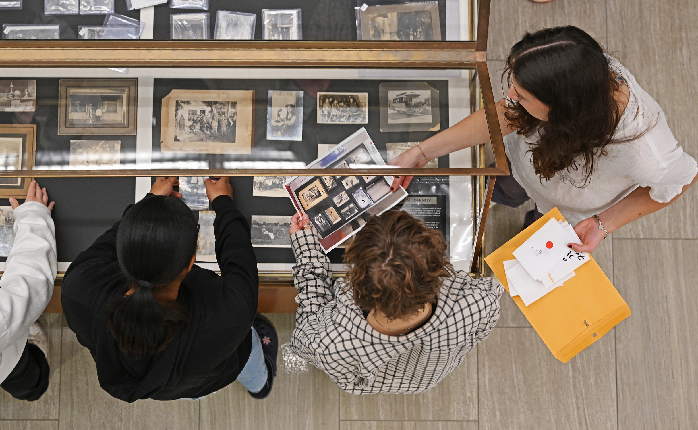 Students installing historical photos