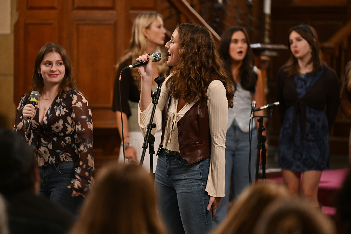 A female performer sings at the a capella Halloween Battle of the Bands.