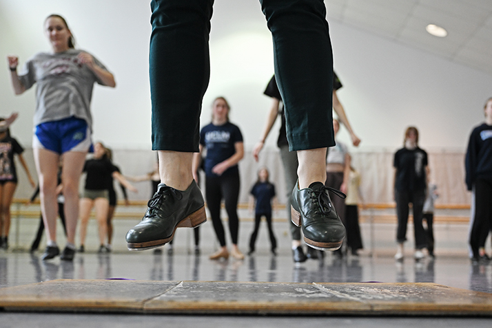 tap dance instructors shoes frame dance students in background