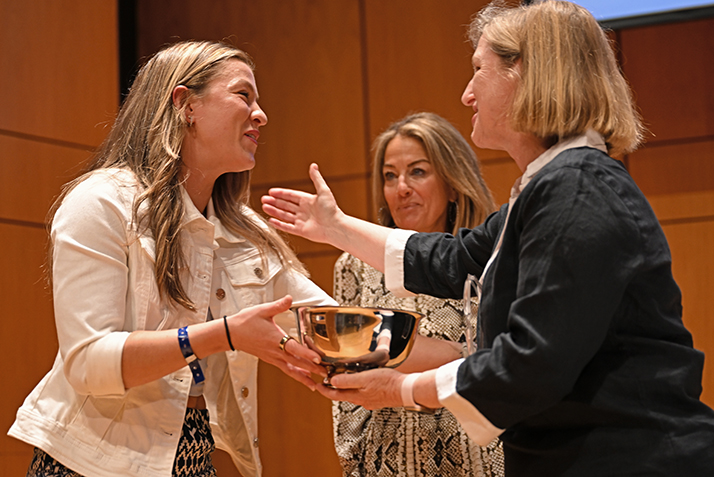 A student athlete is presented with an award on stage