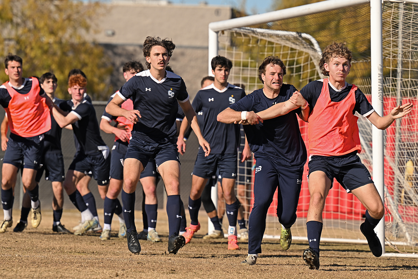 Soccer players practice their corner kicks.