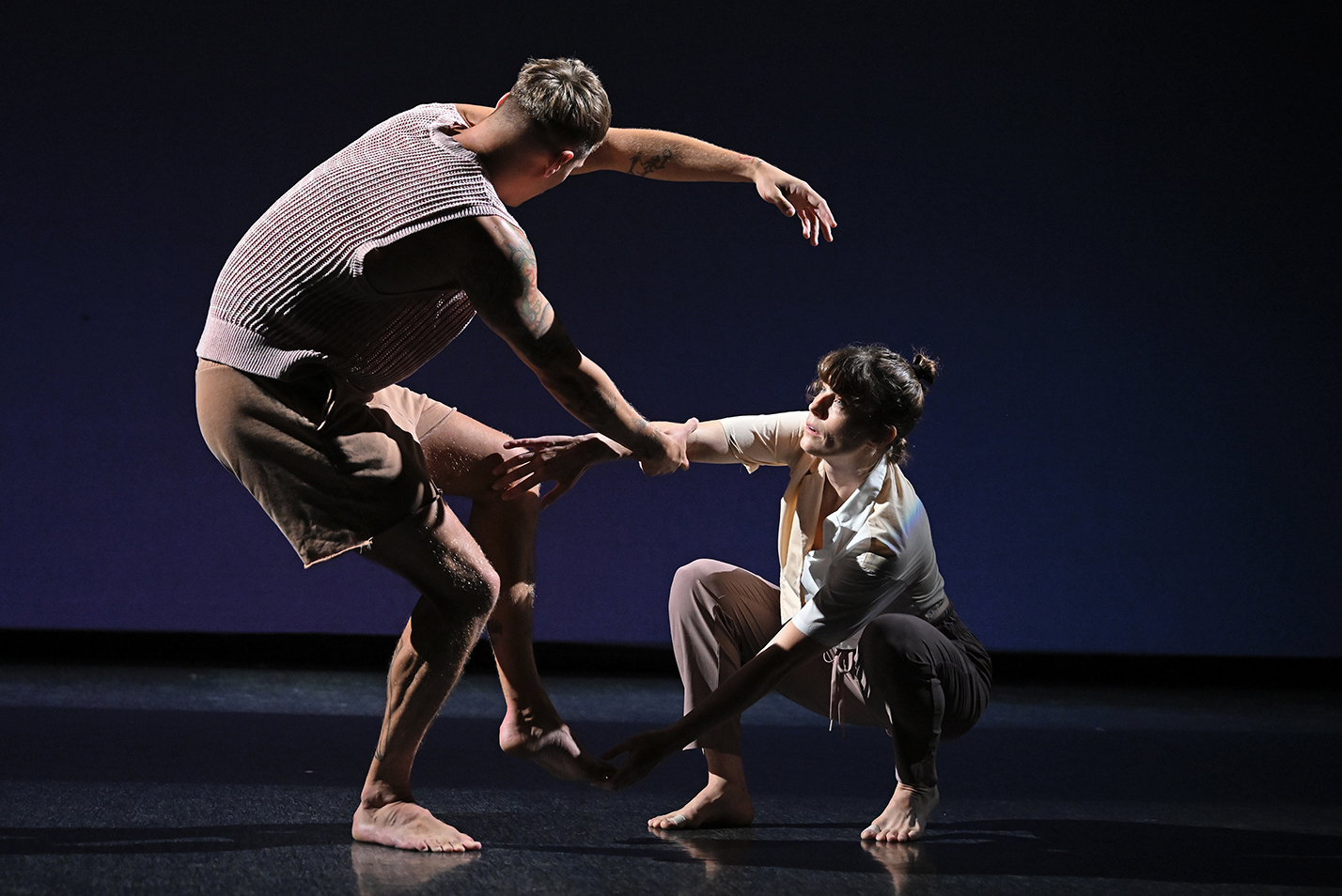 two dancers disentangle themselves during a performance